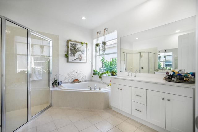 bathroom featuring tile patterned floors, plus walk in shower, vanity, and a wealth of natural light