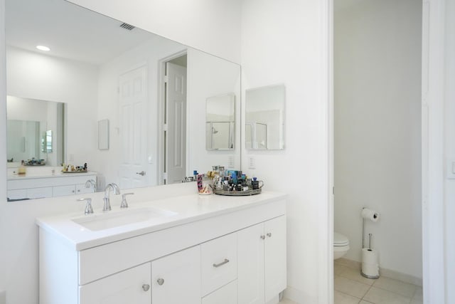 bathroom with vanity, tile patterned floors, and toilet