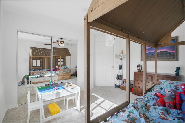 carpeted bedroom featuring lofted ceiling, a closet, and wooden ceiling