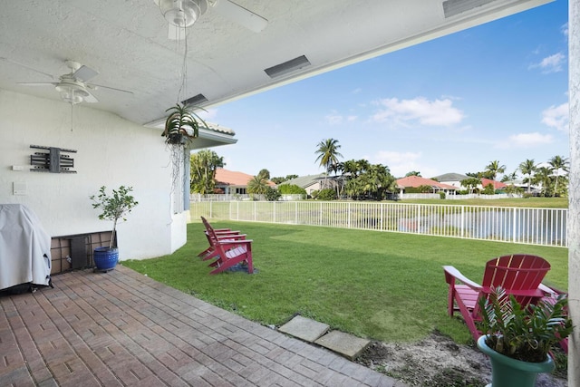 view of yard with ceiling fan and a patio area