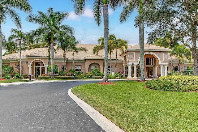 mediterranean / spanish-style house with a front lawn