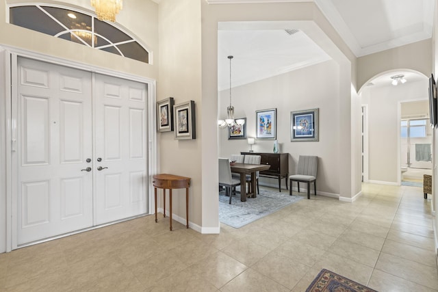 11380 SW Aspen Ln, Port Saint Lucie, FL 34987 - entrance foyer featuring crown molding, light tile patterned floors, and a chandelier