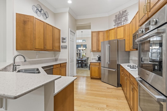 11380 SW Aspen Ln, Port Saint Lucie, FL 34987 - kitchen with sink, light hardwood / wood-style flooring, stainless steel appliances, and kitchen peninsula