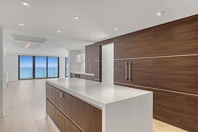 4000 S Ocean Blvd Unit 401, South Palm Beach, FL 33480 - kitchen featuring modern cabinets, a center island, light wood-type flooring, light countertops, and recessed lighting