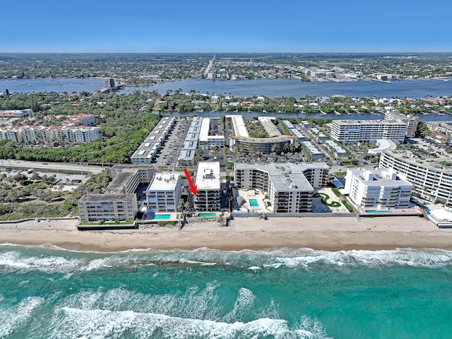 aerial view featuring a water view, a view of city, and a view of the beach