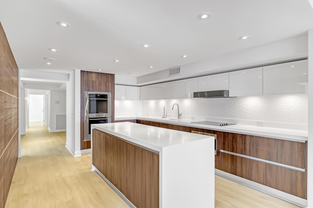4000 S Ocean Blvd Unit 401, South Palm Beach, FL 33480 - kitchen with modern cabinets, stainless steel double oven, white cabinets, light wood-style flooring, and recessed lighting