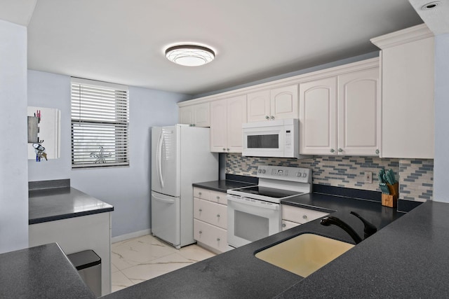 kitchen with sink, white appliances, decorative backsplash, and white cabinets