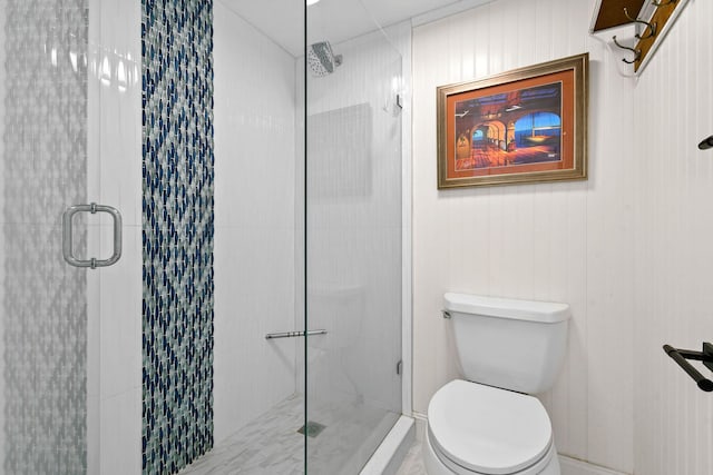 bathroom with a shower with shower door and toilet