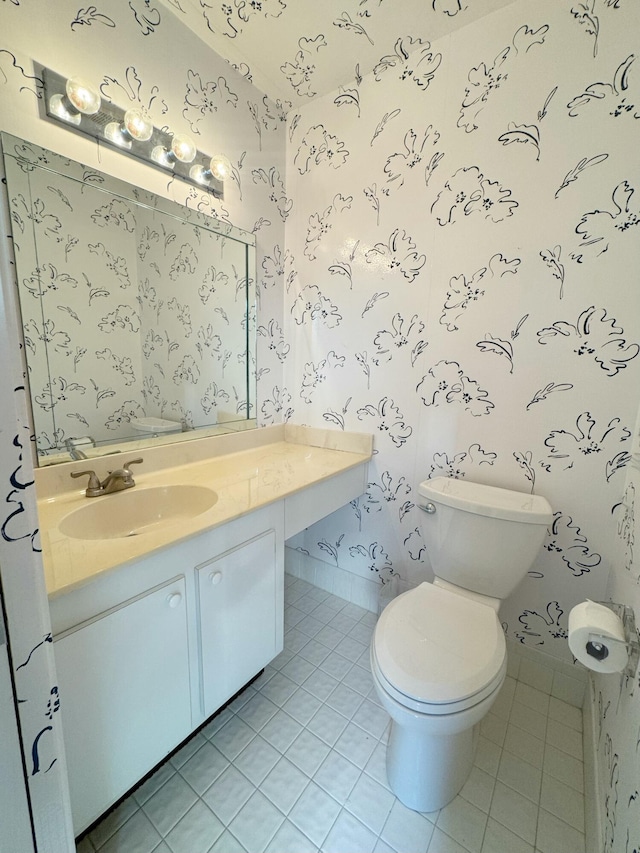 bathroom featuring vanity, tile patterned floors, and toilet