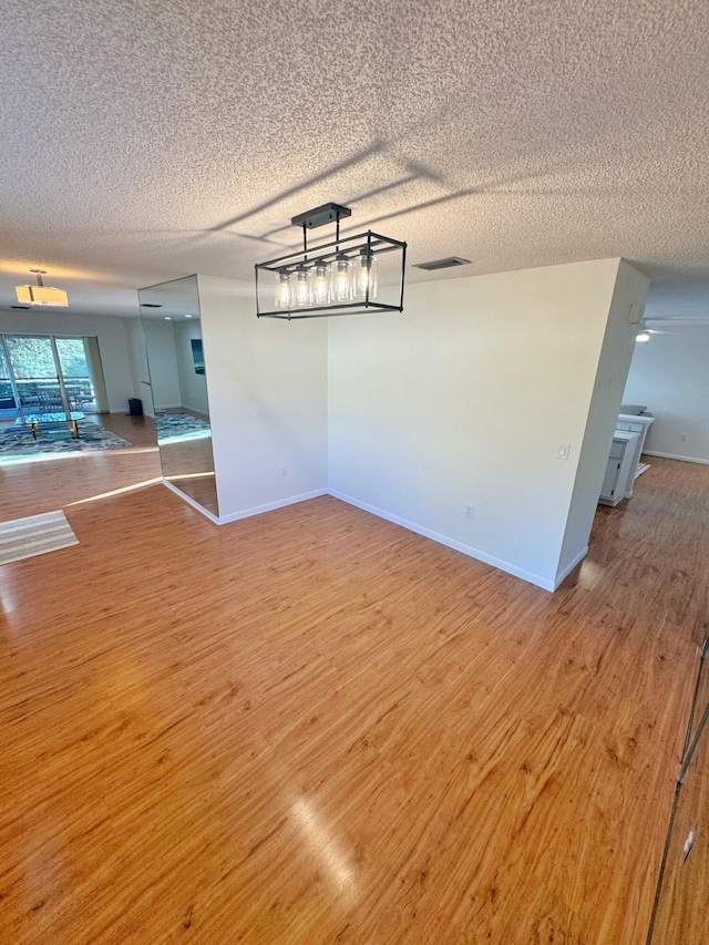 interior space featuring hardwood / wood-style floors and a textured ceiling