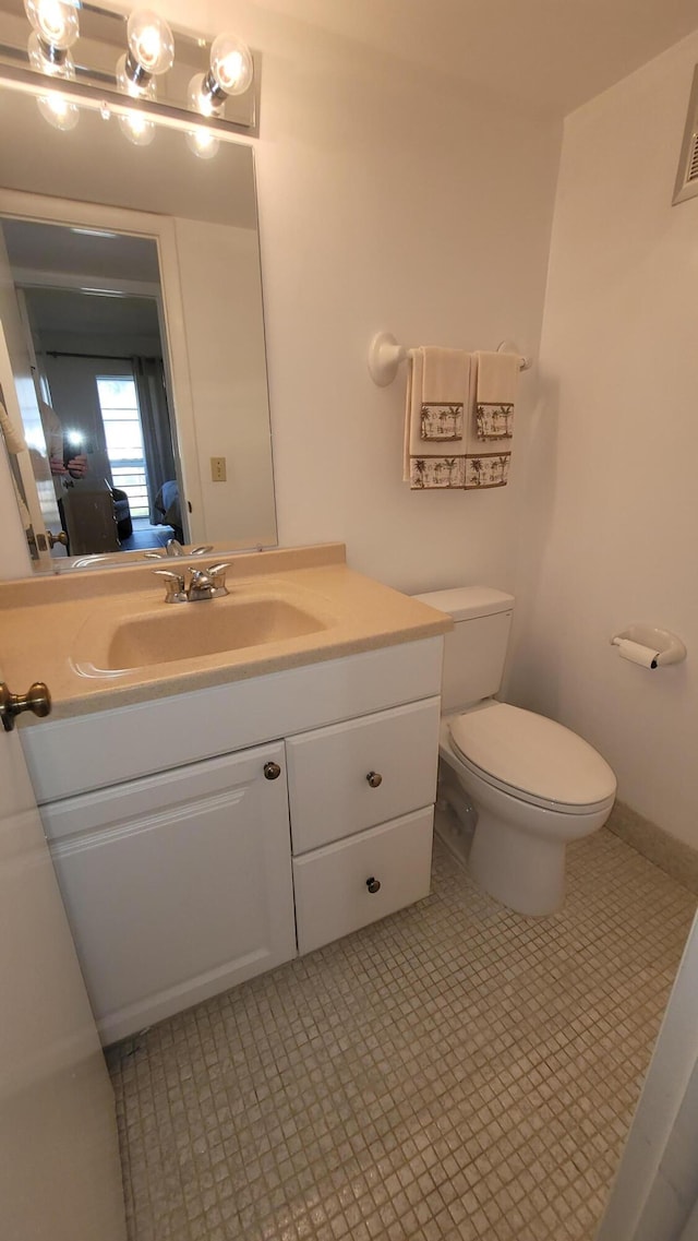 bathroom featuring vanity and toilet