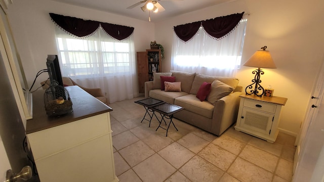 living room featuring light tile patterned floors, a wealth of natural light, and ceiling fan