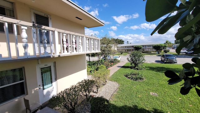 view of yard with a balcony