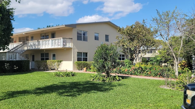 rear view of property with a lawn