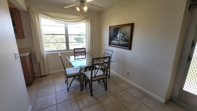 tiled dining room with ceiling fan