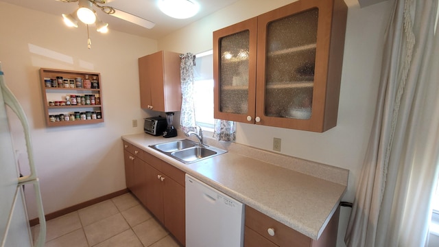 kitchen with sink, white appliances, light tile patterned floors, and ceiling fan