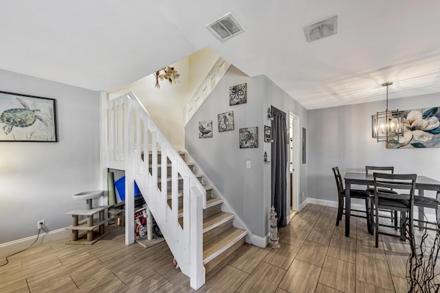 stairway featuring an inviting chandelier