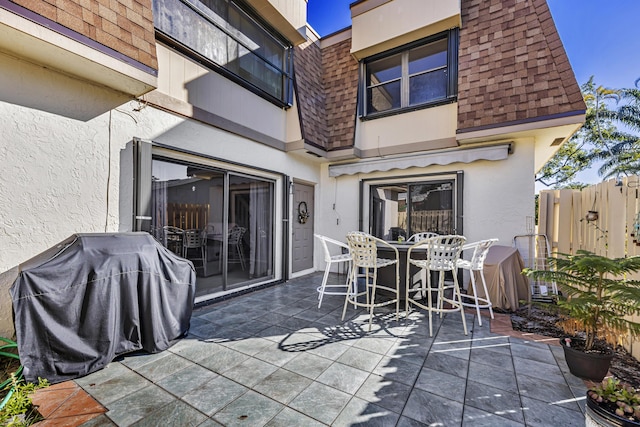 view of patio / terrace featuring fence and a grill