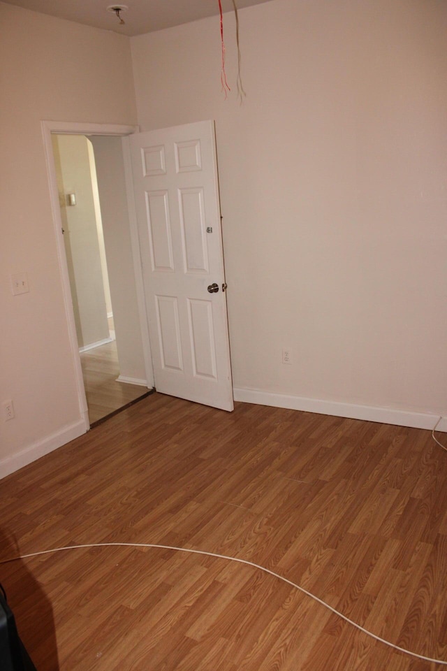 empty room featuring wood-type flooring