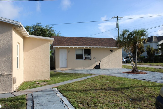 view of home's exterior with a yard and cooling unit