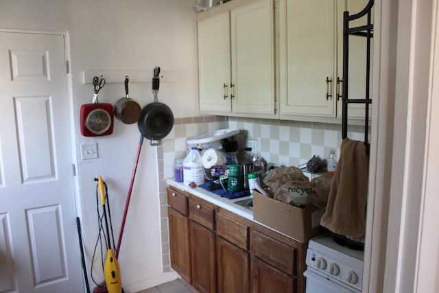 kitchen with backsplash and white stove