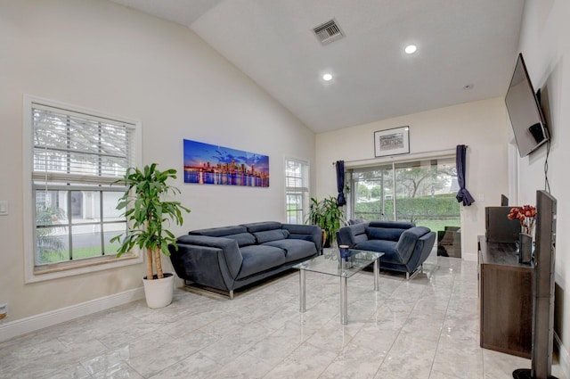 living room featuring high vaulted ceiling