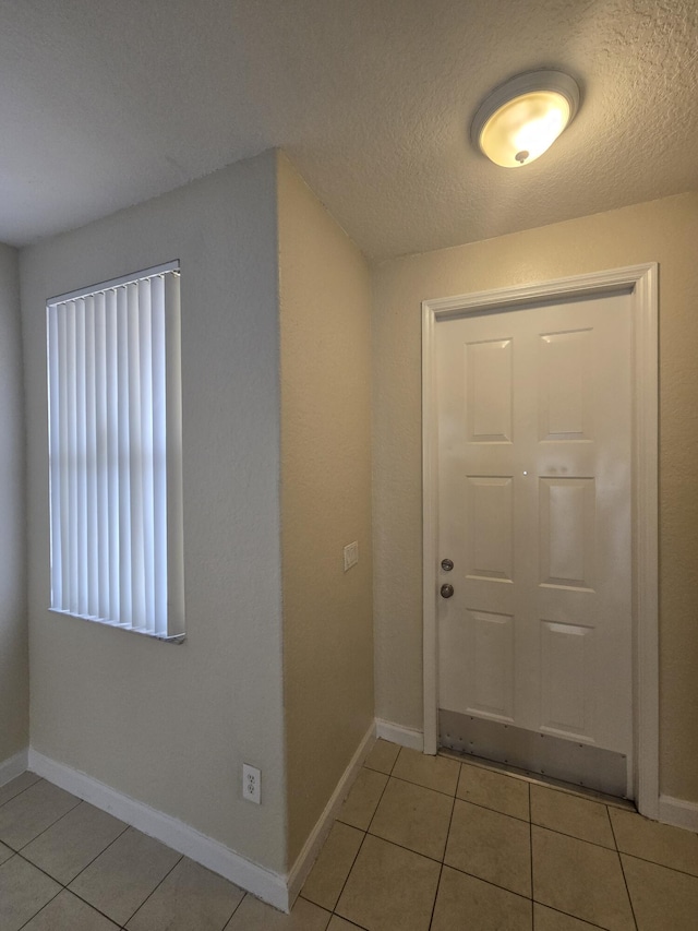 entryway with light tile patterned flooring