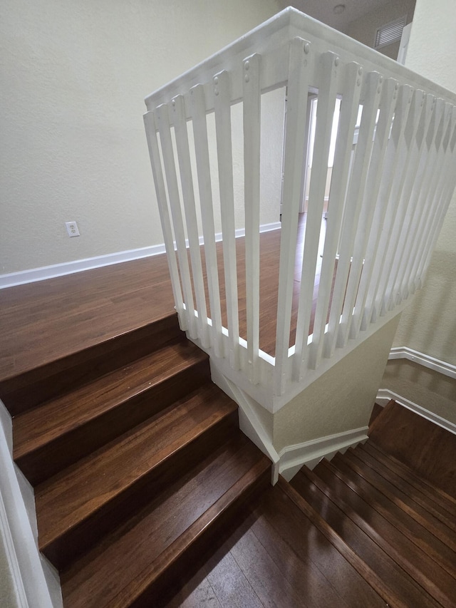 stairs with wood-type flooring