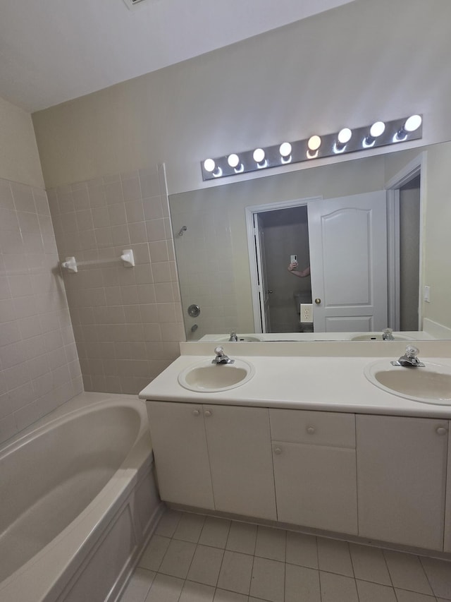 bathroom featuring vanity, bathtub / shower combination, and tile patterned flooring