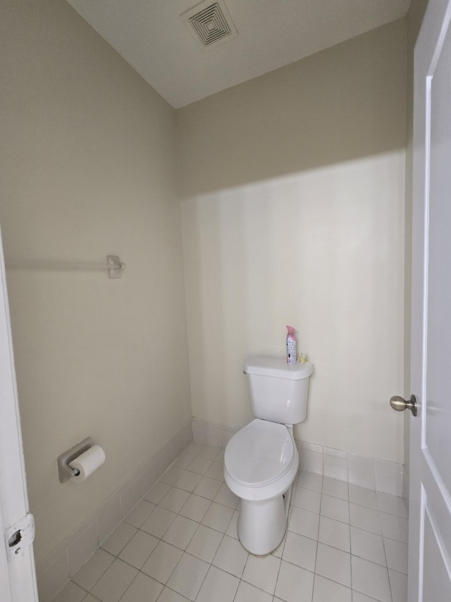 bathroom featuring toilet and tile patterned flooring