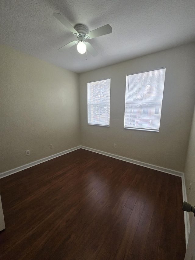 unfurnished room with ceiling fan and dark hardwood / wood-style floors