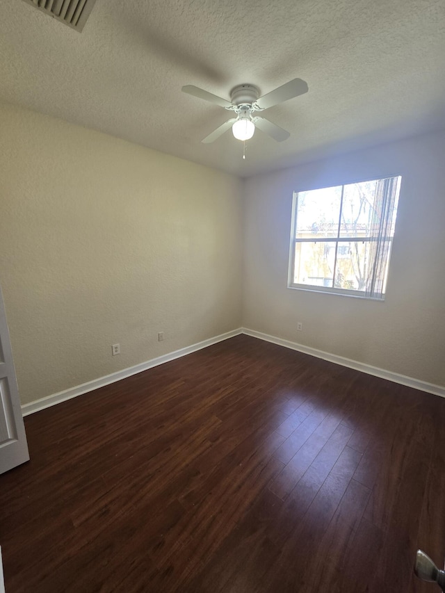 unfurnished room featuring ceiling fan, a textured ceiling, and dark hardwood / wood-style flooring