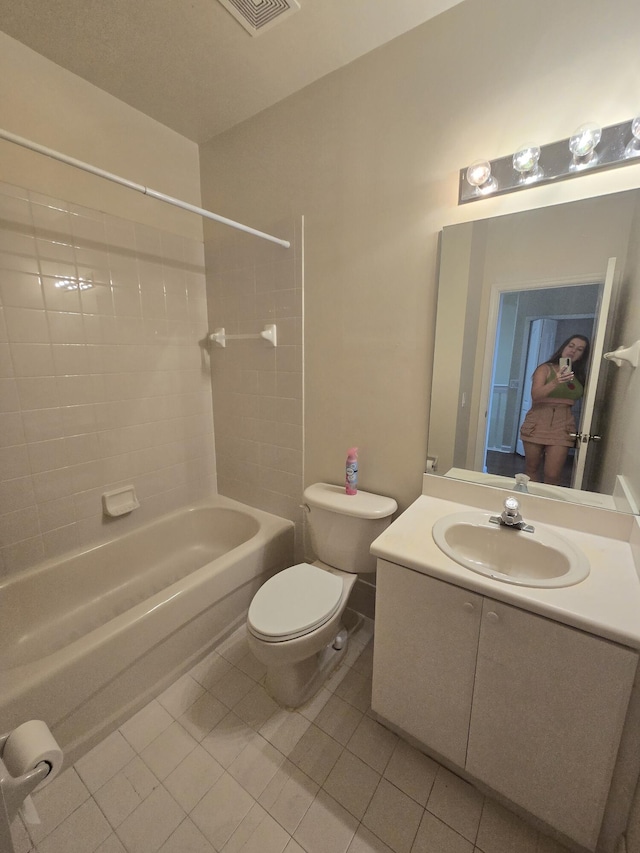 full bathroom featuring vanity, tile patterned floors, bathing tub / shower combination, and toilet