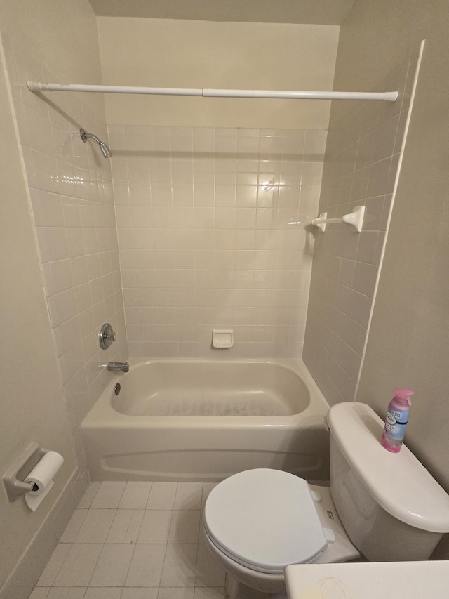 bathroom featuring tile patterned flooring, bathtub / shower combination, and toilet