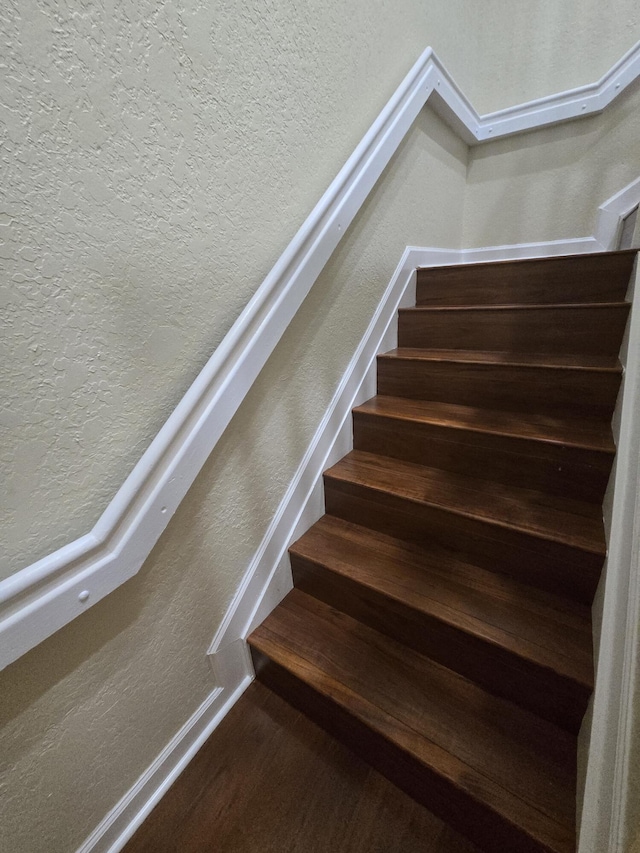 stairway with hardwood / wood-style flooring