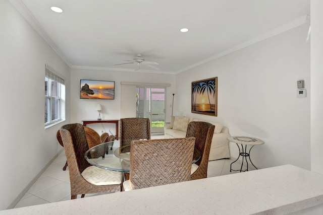 tiled dining room featuring crown molding and ceiling fan