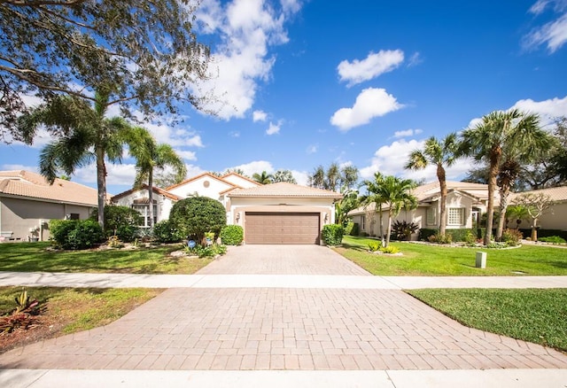 view of front of property with a front yard and a garage