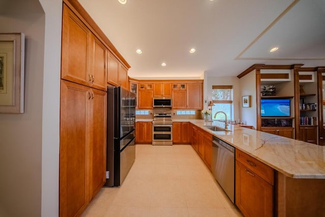7551 Monticello Way, Boynton Beach, FL 33437 - kitchen with appliances with stainless steel finishes, a peninsula, brown cabinets, recessed lighting, and glass insert cabinets