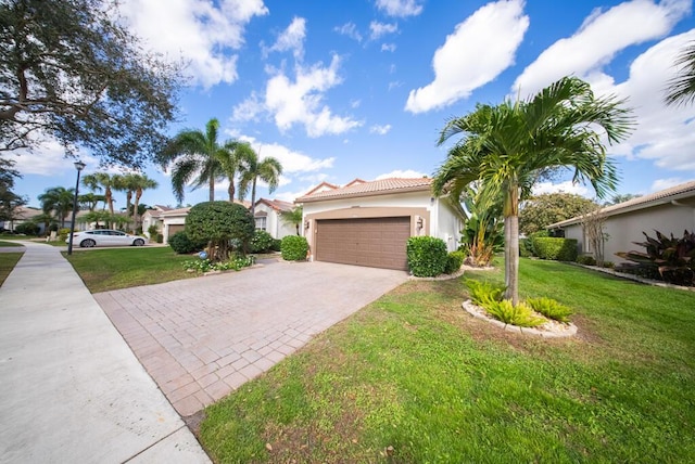 mediterranean / spanish-style home featuring a front yard and a garage