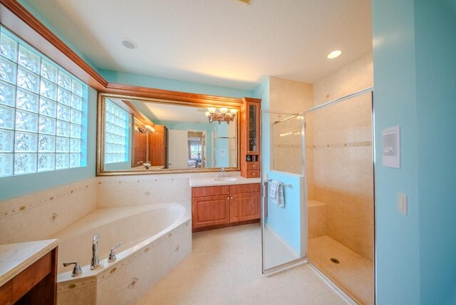 bathroom featuring an inviting chandelier, vanity, plus walk in shower, and tile patterned flooring