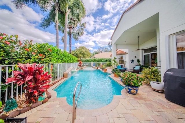 view of pool with a patio and pool water feature