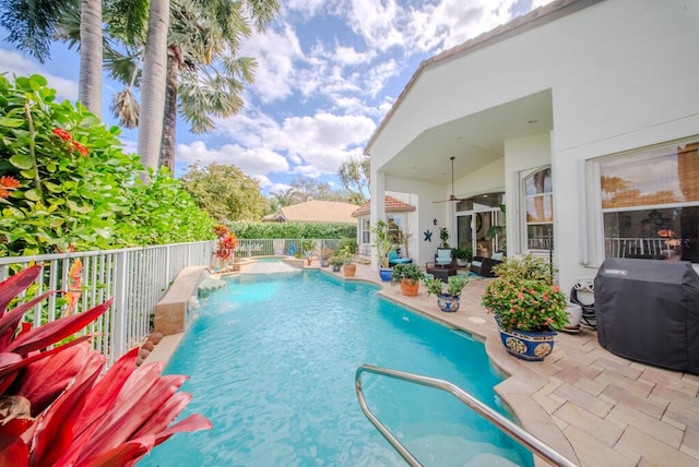 view of pool featuring a patio, pool water feature, and a grill