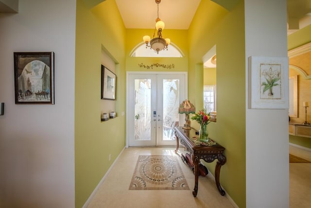 7551 Monticello Way, Boynton Beach, FL 33437 - entrance foyer with french doors, a chandelier, arched walkways, and lofted ceiling