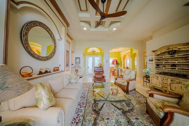 living room with beamed ceiling, coffered ceiling, and french doors