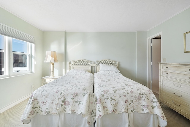 bedroom featuring ornamental molding and carpet