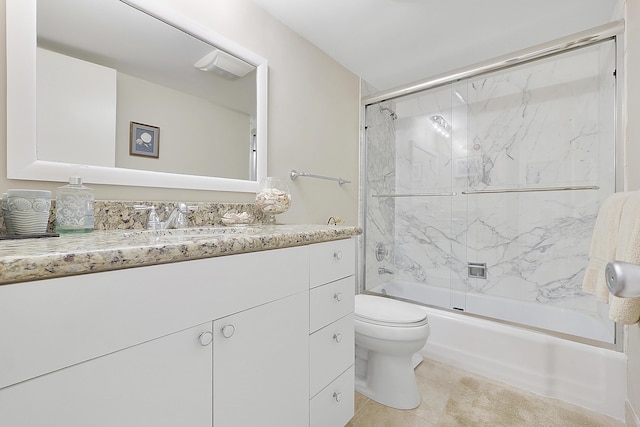 full bathroom featuring enclosed tub / shower combo, vanity, tile patterned floors, and toilet