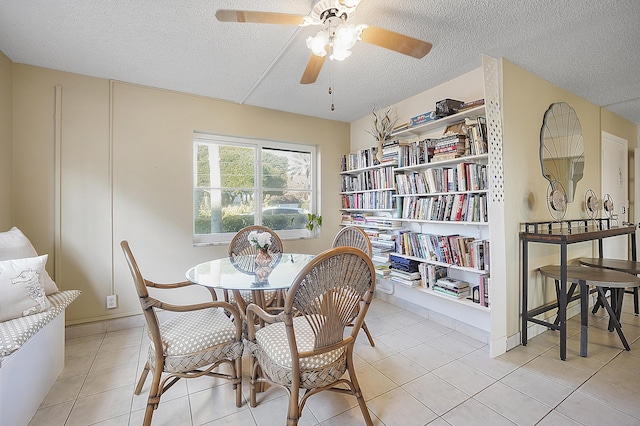 tiled dining area featuring ceiling fan and a textured ceiling