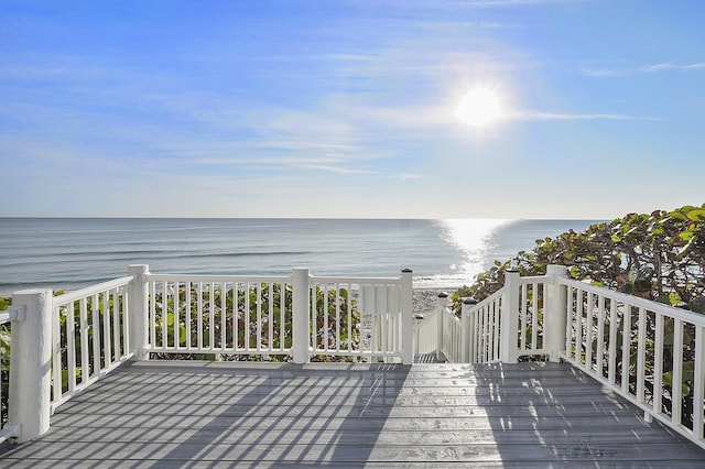 deck featuring a water view and a view of the beach