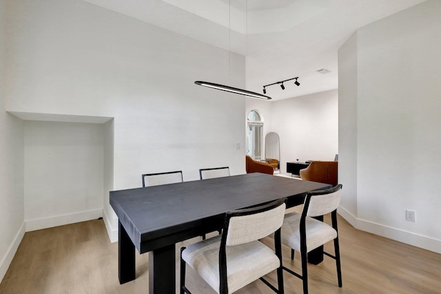 dining space with light hardwood / wood-style floors