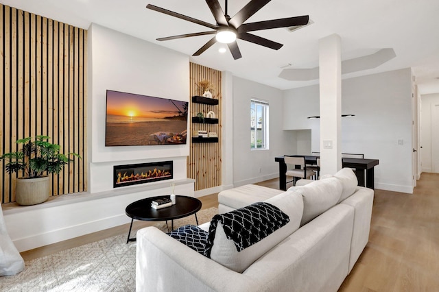 living room with ceiling fan and light wood-type flooring